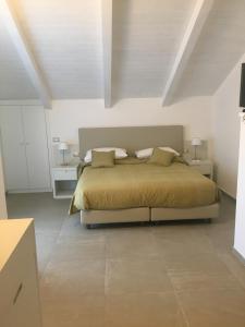 a bedroom with a bed in a white room at Villa Donatella in Paestum
