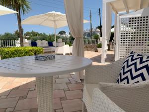 a patio area with chairs, tables and umbrellas at Boutique B&B Bettola Del Re in Anacapri