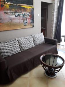 a living room with a brown couch and a table at Carrer Roma in Sagunto