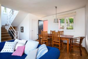 a living room with a blue couch and a table at La Caleta in Begur