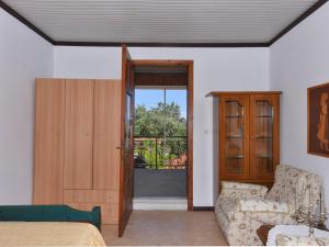 a living room with a couch and a sliding glass door at Ammos House Seaview - Agios Mamas Beach in Áyios Mámas