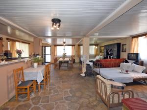 a living room with a couch and a table at Ammos House Seaview - Agios Mamas Beach in Áyios Mámas
