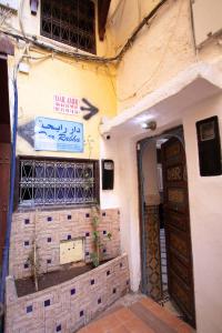a building with a door and a sign on it at Hostel Amir in Fez