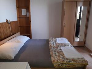 a bedroom with a bed with a pillow and a door at Apartmani Ana Novi V. - studio in Novi Vinodolski