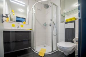 a bathroom with a shower and a toilet and a sink at Design-Apartments by Ulrike Horster in Bensheim