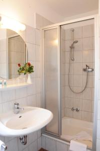 a bathroom with a shower and a sink at Hotel Zur Traube in Velbert