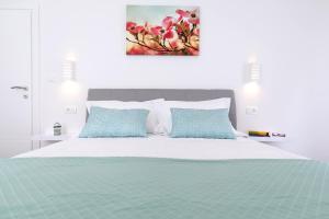 a bedroom with a bed with blue pillows at Villa Magdalena in Porat +38 photos