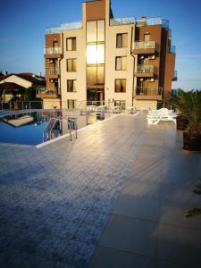a large building with a pool in front of it at Aparthotel Afrodita 2 in Sinemorets