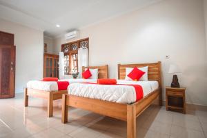 Postel nebo postele na pokoji v ubytování Satya House Ubud