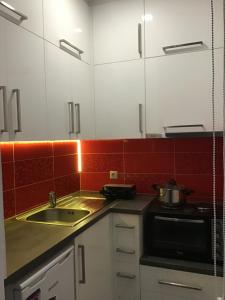 a kitchen with a sink and a microwave at Summer Studio - Zakynthos!! in Argassi