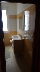 a bathroom with a sink and a mirror at B&B Il Porto Vecchio in Stintino