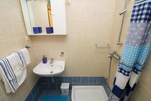 a bathroom with a sink and a toilet and a mirror at Apartments Ines in Baška