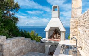 a outdoor kitchen with a view of the ocean at Apartman Sunrise in Vela Luka