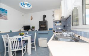 a kitchen with a sink and a table at Apartman Sunrise in Vela Luka +18 photos