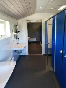 a bathroom with blue cabinets and a sink at Fjellstova Ørskogfjellet Cottages in Sjøholt