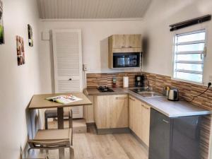 a small kitchen with a table and a sink at COROSSOL in Trois-Rivières