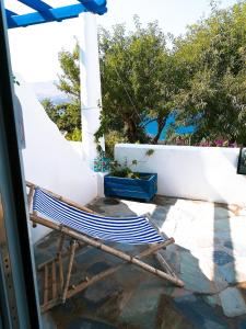 a chair sitting on a patio in front of a house at Il Canto delle Cicale in Agia Marina