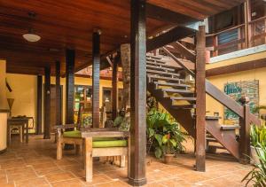 a lobby with a staircase and a table and benches at Lonier Nature INN in Abraão