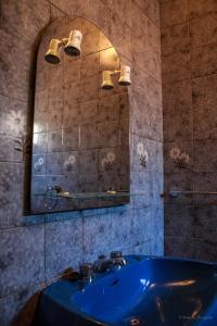 a bathroom with a blue sink and a mirror at Quinta Das Rossadas in Cinfães