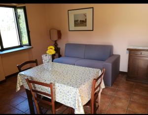 a living room with a table and a couch at Guest House " IL FARINELLO " in Garessio