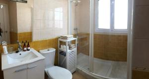 a bathroom with a shower and a toilet and a sink at ATICO SAN MARCOS in El Puerto de Santa María +8 photos