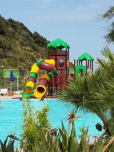 a pool with a water slide in a playground at Elba in relax in Rio Marina