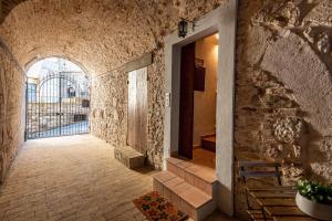 a hallway in a building with a stone wall at La casa dell’artista in Assisi
