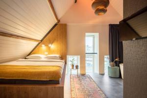 a bedroom with a large bed with a wooden headboard at Bunk Hotel Utrecht in Utrecht