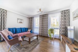 Televízia a/alebo spoločenská miestnosť v ubytovaní Apartament Relax