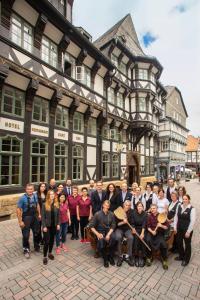 a large group of people standing in front of a building at Romantik Hotel Alte Münze in Goslar