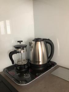 a tea kettle and coffee pot on a tray at Apartmani ROBERTA in Bol