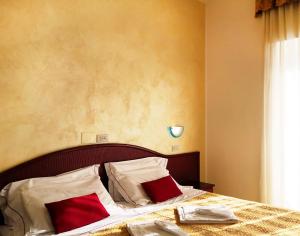 Postel nebo postele na pokoji v ubytování Hotel Vittoria - Nuova Gestione
