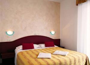 Postel nebo postele na pokoji v ubytování Hotel Vittoria - Nuova Gestione