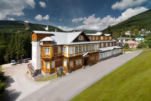 an aerial view of a large house with a hill at Hotel Sněžka in Špindlerův Mlýn