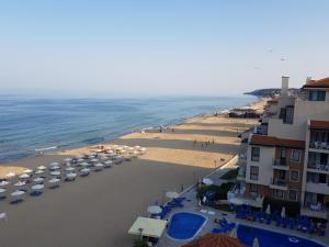 a view of a beach with umbrellas and the ocean at Apartment with Sea View in Obzor Beach in Obzor