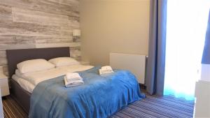 Posteľ alebo postele v izbe v ubytovaní Apartamenty Krynica No.1