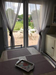 a room with a bed and a window with curtains at joli studio au coeur de Verdun in Verdun