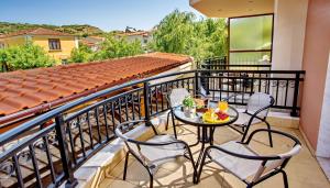 a balcony with a table and chairs on a balcony at Konstantina & Evgenia Deluxe Apartment in Nea Peramos