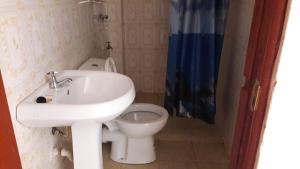 a bathroom with a sink and a toilet at Bondo Travellers Hotel in Bondo
