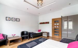 1 dormitorio con cama, sofá y mesa en Rainbow Apartments 1 Premium, en Cracovia