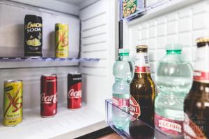 a refrigerator filled with bottles of soda and drinks at Al centro di Roma in Rome