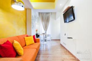 a living room with an orange couch and a tv at Al centro di Roma in Rome