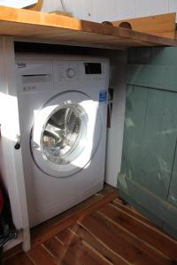 a washing machine in a room with a shelf at Cambridge Boat Hire in Chesterton