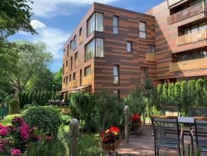 a building with a garden in front of it at Arunes Apartments in Palanga