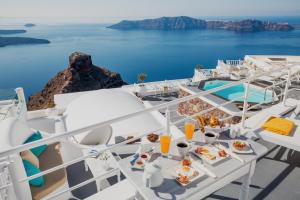 a meal on a cruise ship with a view of the ocean at Thea Apartments in Imerovigli