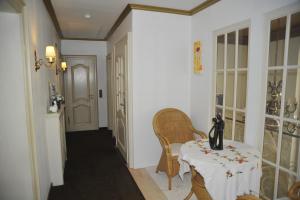 a hallway with a table and chairs and a door at Hotel zur Herzklinik in Bad Oeynhausen