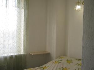 a bedroom with a bed and a window at Мини отель П88/1 in Odesa