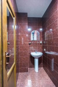 a bathroom with a toilet and a sink and a shower at Apartament on Rustaveli in Batumi +12 photos