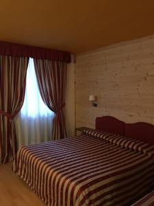 a hotel room with a bed and a window at Albergo Aprica Garni in Aprica