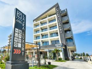 a building with a sign in front of it at Hotel Lajka Luxury in Ulcinj